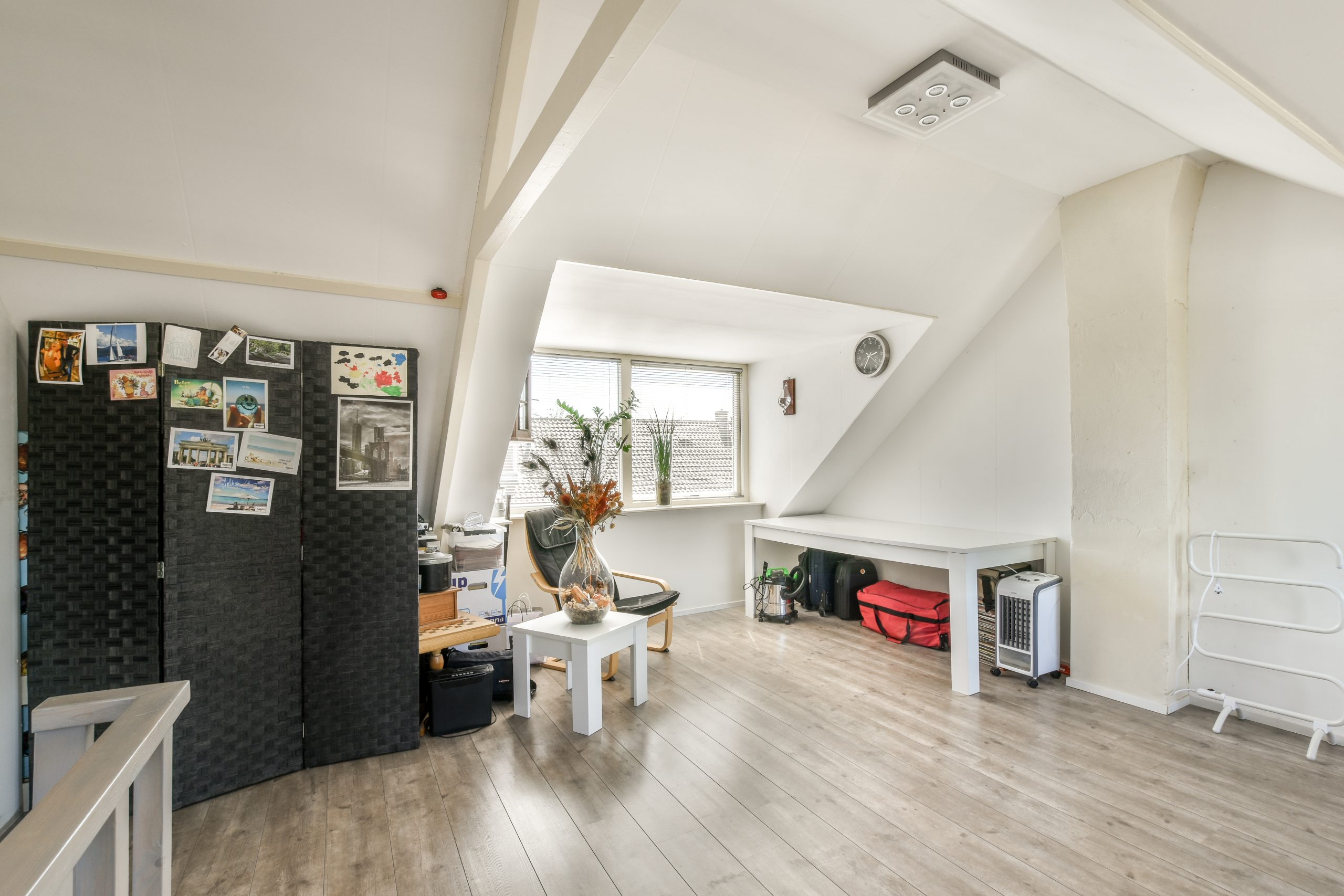 Amsterdam, Netherlands - 10 April, 2021: a living room with white walls and wood flooring the room is very spacious, but it's not too